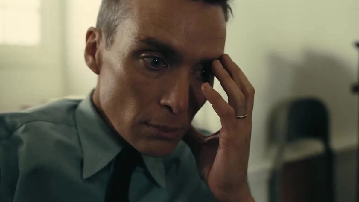 Cillian Murphy holds his hand over his eye as he contemplates horrors in Oppenheimer.